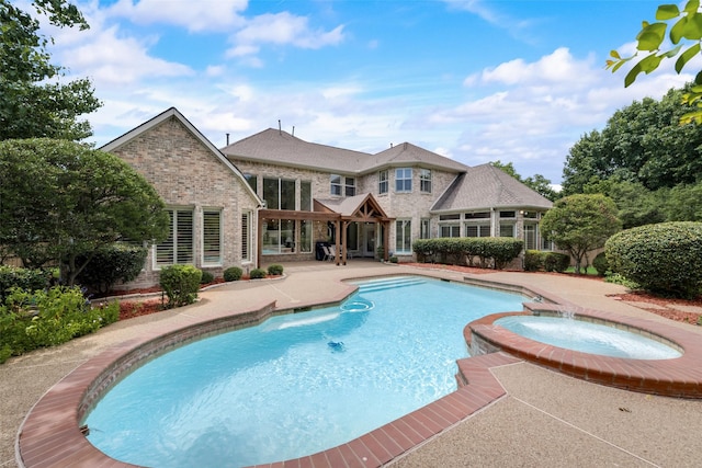 view of swimming pool with an in ground hot tub, pool water feature, and a patio