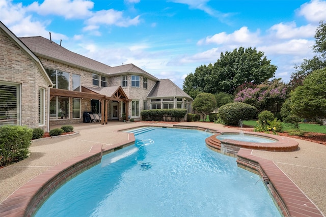 view of swimming pool featuring a patio area and an in ground hot tub