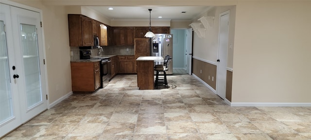 kitchen featuring tasteful backsplash, light tile patterned floors, a center island, stainless steel appliances, and hanging light fixtures