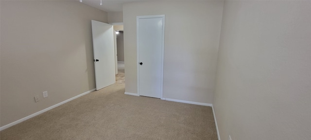 unfurnished room featuring carpet flooring