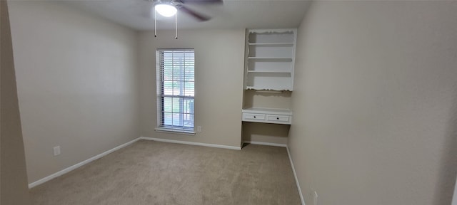 unfurnished bedroom with multiple windows, carpet, and ceiling fan