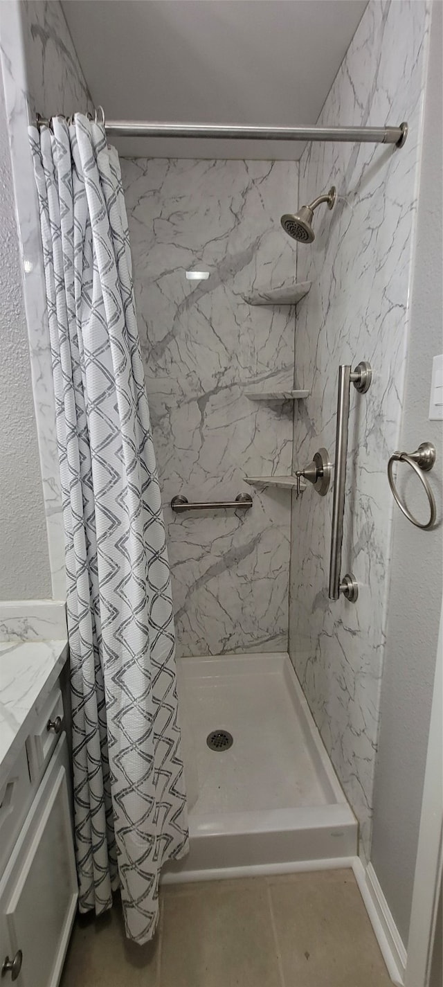 bathroom with tile patterned floors, a shower with curtain, and vanity