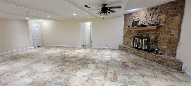 unfurnished living room with a stone fireplace, tile patterned flooring, and ceiling fan