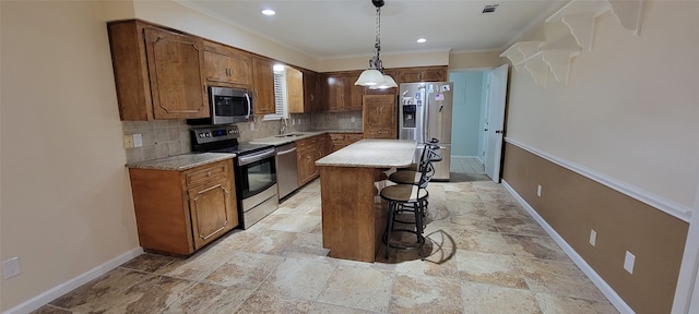 kitchen featuring stainless steel appliances, hanging light fixtures, backsplash, light tile patterned floors, and a center island