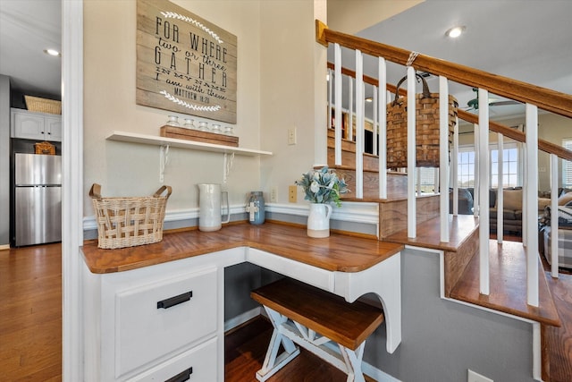 kitchen featuring white cabinetry, dark hardwood / wood-style flooring, and stainless steel fridge