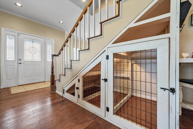 entrance foyer with crown molding and hardwood / wood-style flooring