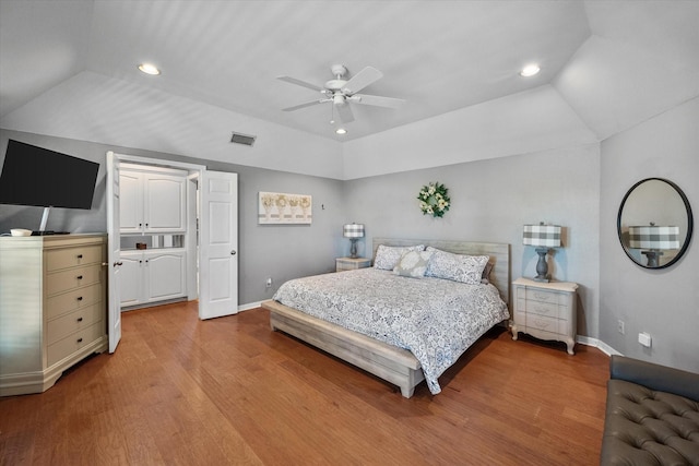 bedroom with ceiling fan, lofted ceiling, and wood-type flooring