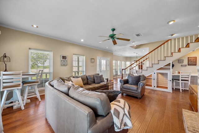 living room with ceiling fan, crown molding, and hardwood / wood-style floors