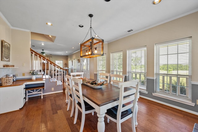 dining room with ceiling fan, dark hardwood / wood-style flooring, and ornamental molding