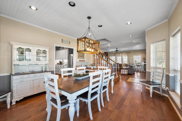 dining area featuring ceiling fan, dark hardwood / wood-style floors, and ornamental molding