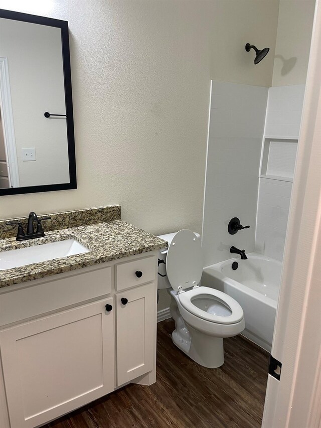 full bathroom with vanity, toilet, shower / bathing tub combination, and hardwood / wood-style flooring