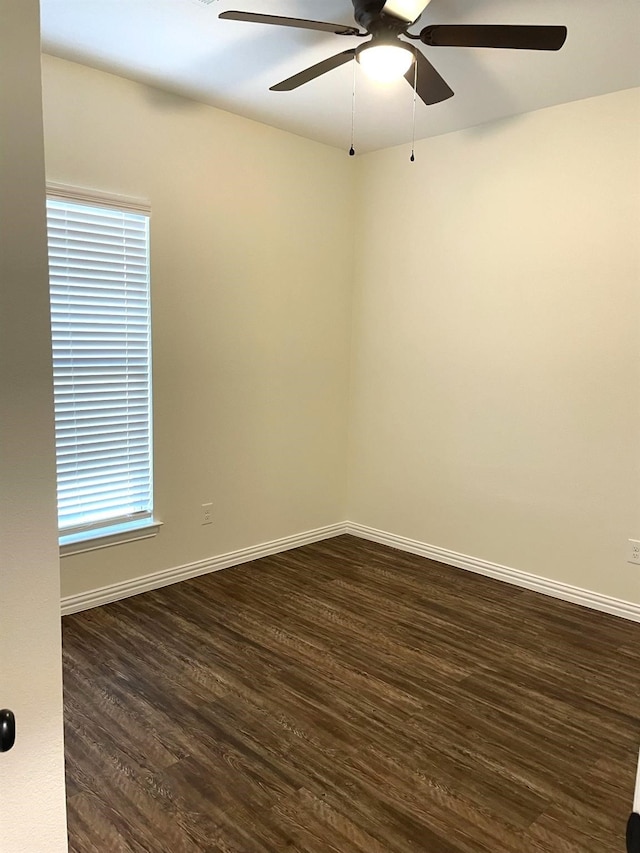 spare room featuring dark hardwood / wood-style flooring and ceiling fan