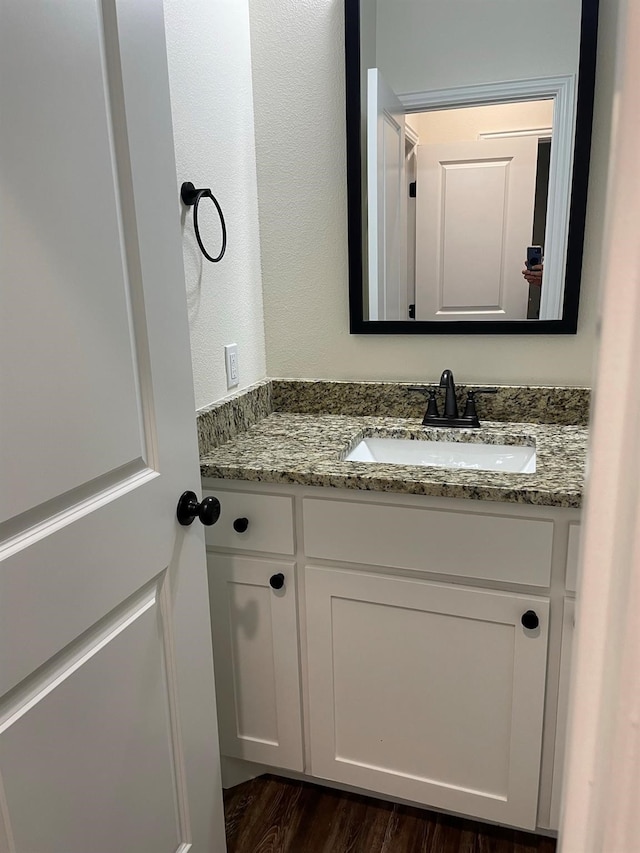 bathroom with vanity and hardwood / wood-style flooring