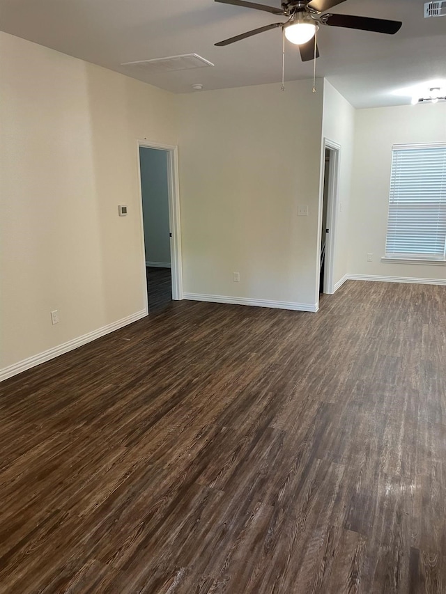 empty room featuring ceiling fan and dark wood-type flooring