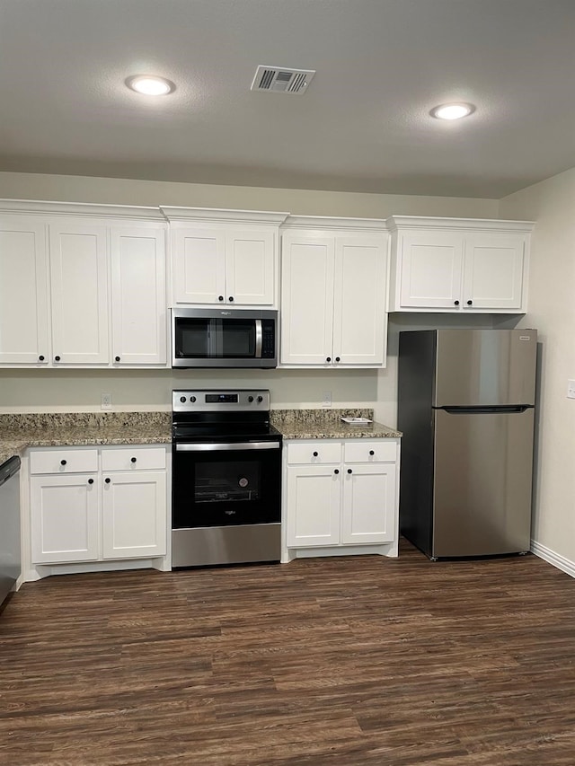 kitchen with white cabinets, stainless steel appliances, and dark hardwood / wood-style flooring