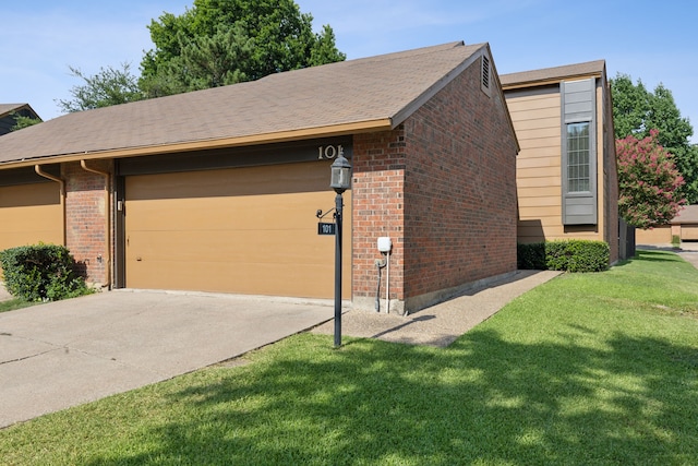 ranch-style house with a garage and a front lawn