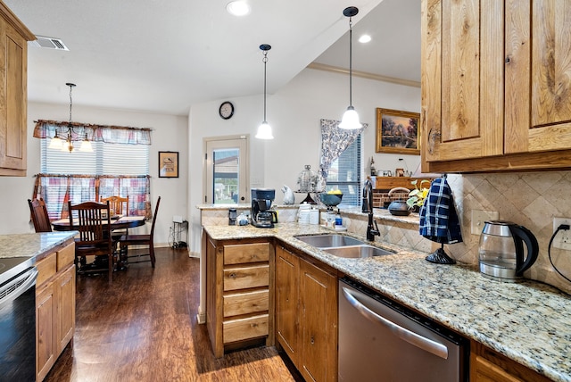 kitchen with appliances with stainless steel finishes, dark hardwood / wood-style floors, light stone counters, and sink