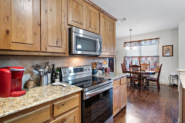 kitchen with light stone countertops, decorative light fixtures, stainless steel appliances, decorative backsplash, and dark hardwood / wood-style floors