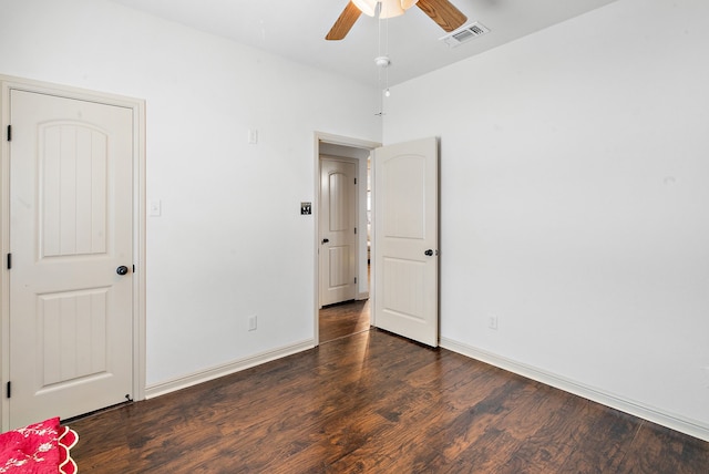 unfurnished bedroom featuring ceiling fan and dark hardwood / wood-style flooring