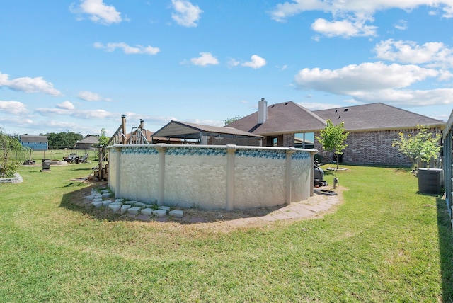 view of swimming pool featuring cooling unit and a lawn