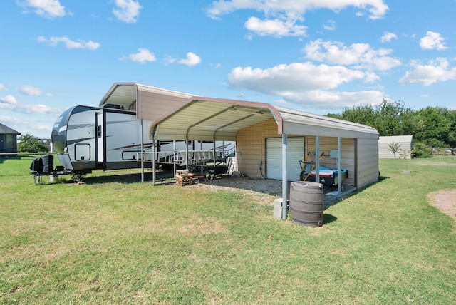 view of outdoor structure with a carport and a yard