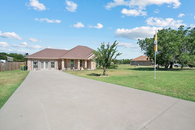 single story home featuring a front lawn and french doors