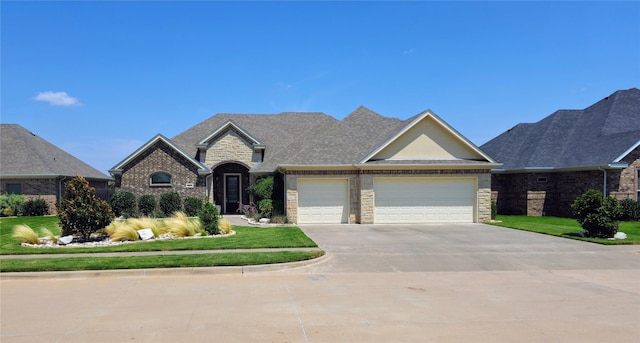 view of front of property with an attached garage, stone siding, a front lawn, and concrete driveway