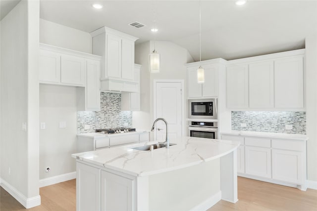 kitchen with white cabinetry, sink, hanging light fixtures, a kitchen island with sink, and stainless steel appliances