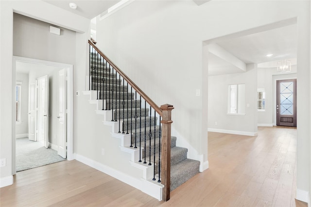 entryway featuring an inviting chandelier and light wood-type flooring