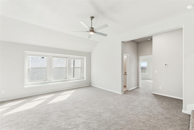 spare room with a healthy amount of sunlight, light colored carpet, and ceiling fan