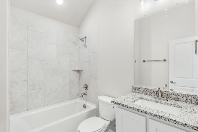 full bathroom with tiled shower / bath, vanity, and toilet