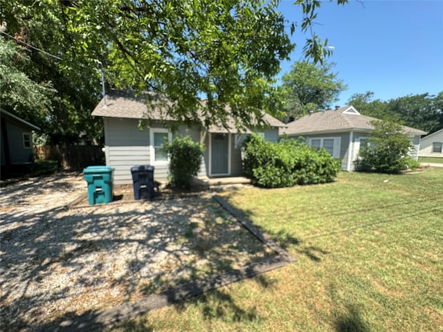 rear view of house with a yard