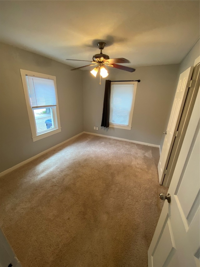 spare room with carpet and ceiling fan