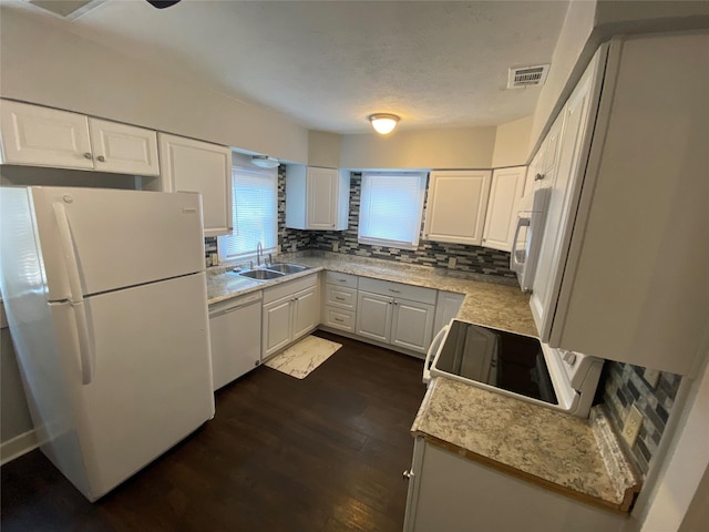 kitchen featuring white appliances, white cabinets, decorative backsplash, sink, and dark hardwood / wood-style floors