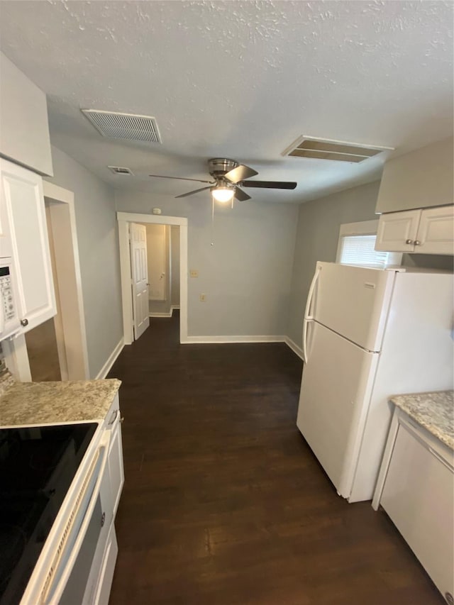 kitchen featuring white cabinets, dark wood-type flooring, and white refrigerator