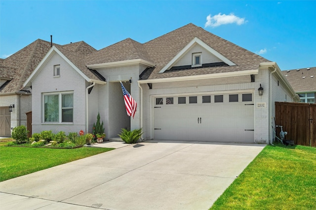 view of front of property featuring a garage and a front lawn