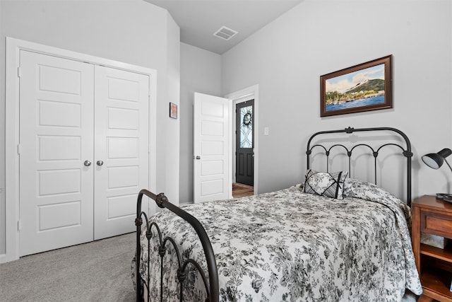 bedroom with light carpet and a closet