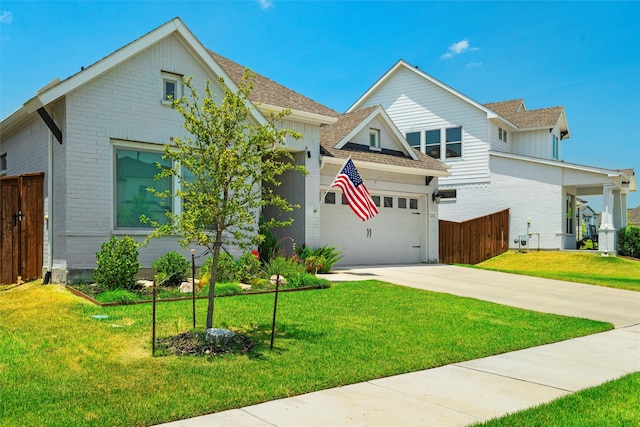 view of front of house with a garage and a front lawn