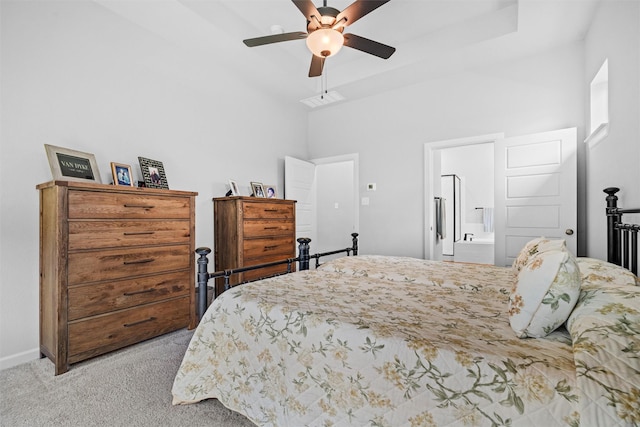 bedroom featuring ceiling fan, ensuite bathroom, and light carpet