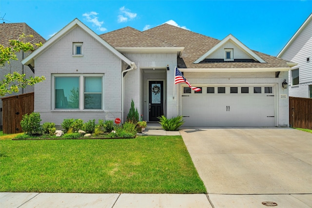 view of front facade featuring a garage and a front lawn