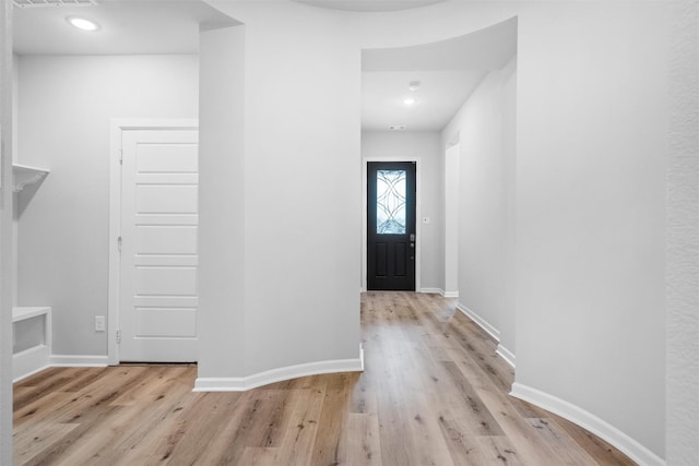 foyer entrance featuring light wood-type flooring and baseboards