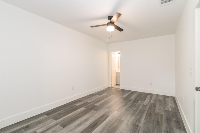 942 County Road 2240, Corsicana, TX 75109 - unfurnished room featuring dark wood-style floors, a ceiling fan, and baseboards