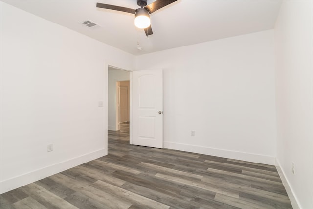 unfurnished room featuring dark wood-type flooring and ceiling fan