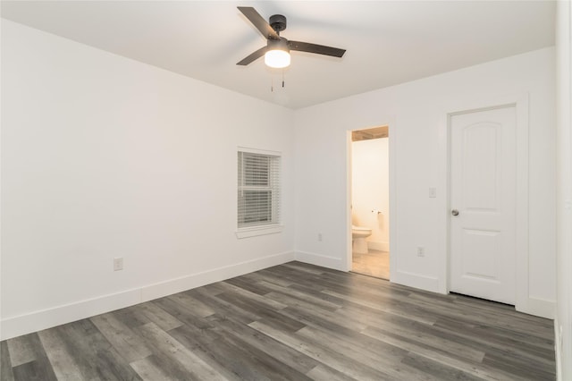942 County Road 2240, Corsicana, TX 75109 - unfurnished bedroom featuring dark wood-style floors, baseboards, ensuite bathroom, and a ceiling fan