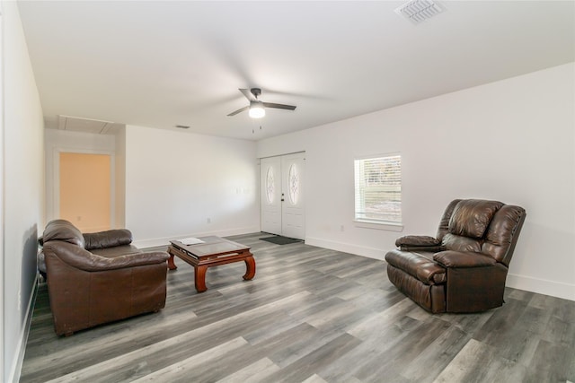 living area featuring hardwood / wood-style flooring and ceiling fan