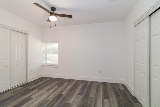 unfurnished bedroom with dark wood-type flooring, ceiling fan, and a closet