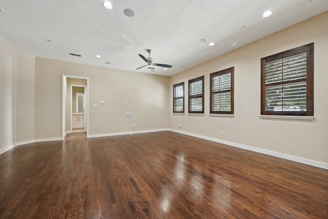 unfurnished living room featuring ceiling fan and dark wood-type flooring