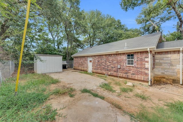 view of side of home with a storage unit