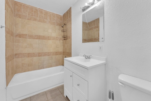 full bathroom with tile patterned floors, toilet, vanity, and tiled shower / bath