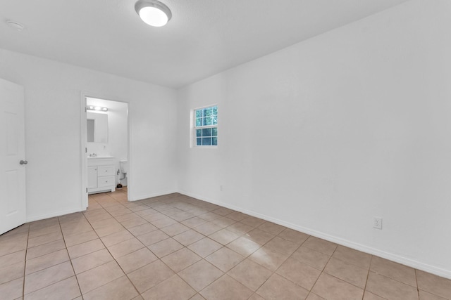 tiled spare room with sink